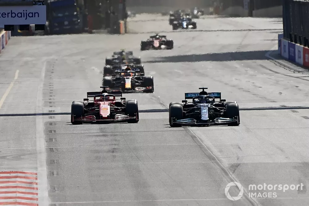 Lewis Hamilton, Mercedes W12, passes Charles Leclerc, Ferrari SF21