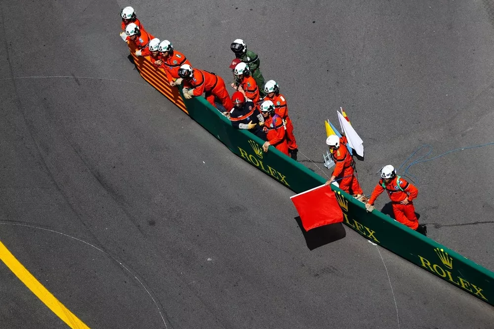 Marshals wave the red flags after an opening lap crash