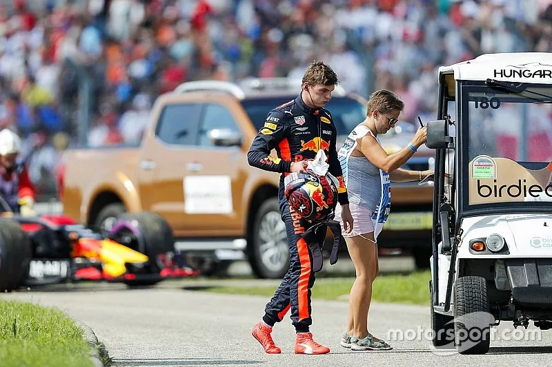 Max Verstappen, Red Bull Racing, gets a lift back to the pits after retiring from the race