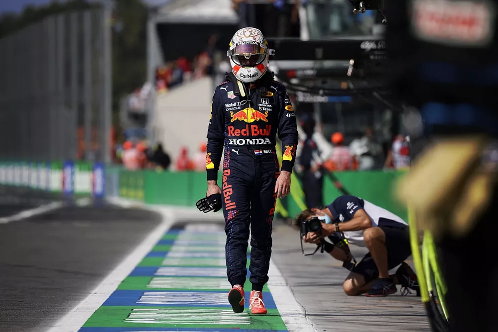 A dejected Max Verstappen, Red Bull Racing, walks back to the pits after crashing out with Lewis Hamilton, Mercedes