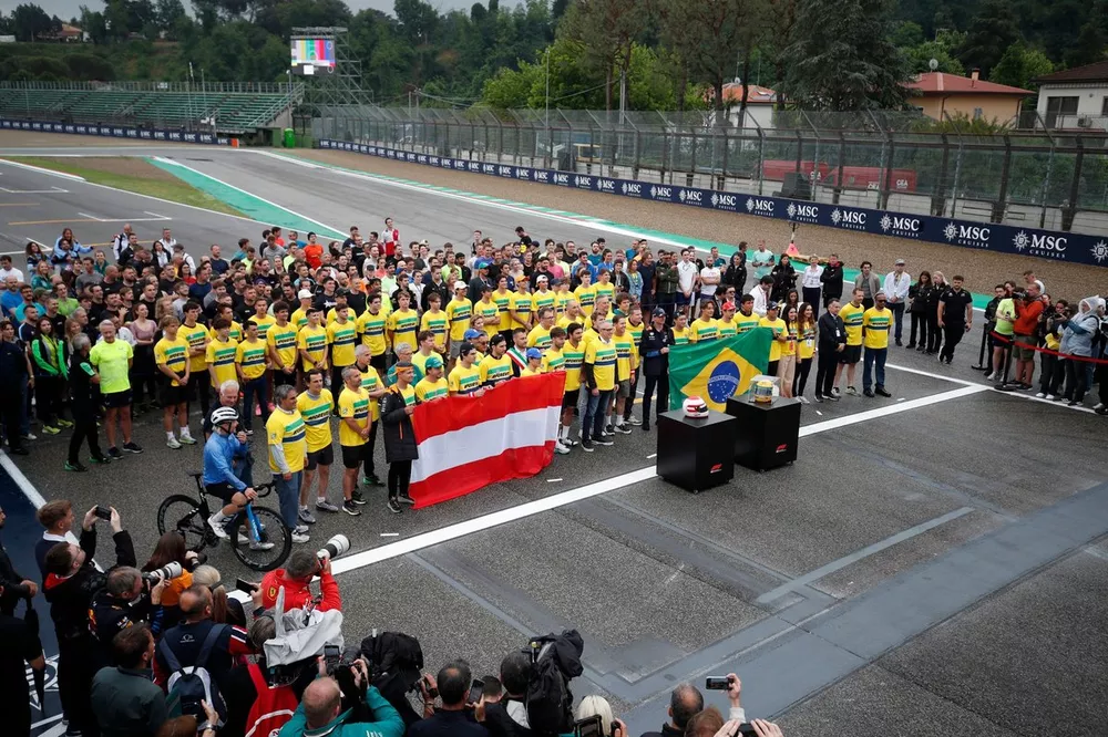 Drivers of the Formula 1, Formula 2, Formula 3 paddocks stand on the grid in memory of Ayrton Senna and Roland Ratzenberger