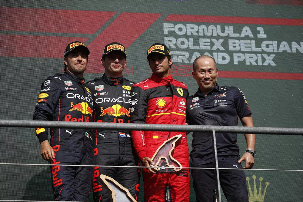 Sergio Perez, Red Bull Racing, 2nd position, Max Verstappen, Red Bull Racing, 1st position, Carlos Sainz, Ferrari, 3rd position, the Red Bull trophy delegate on the podium
