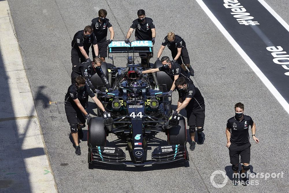 Mechanics assist Lewis Hamilton, Mercedes F1 W11 , in Parc Ferme