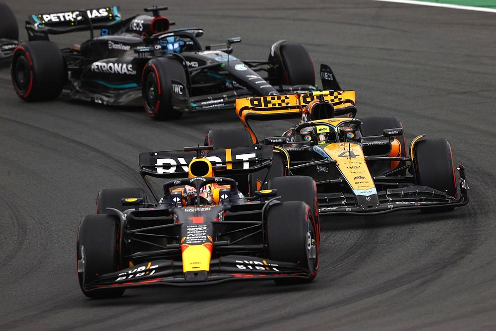 Max Verstappen, Red Bull Racing RB19, leads Lando Norris, McLaren MCL60, and George Russell, Mercedes F1 W14