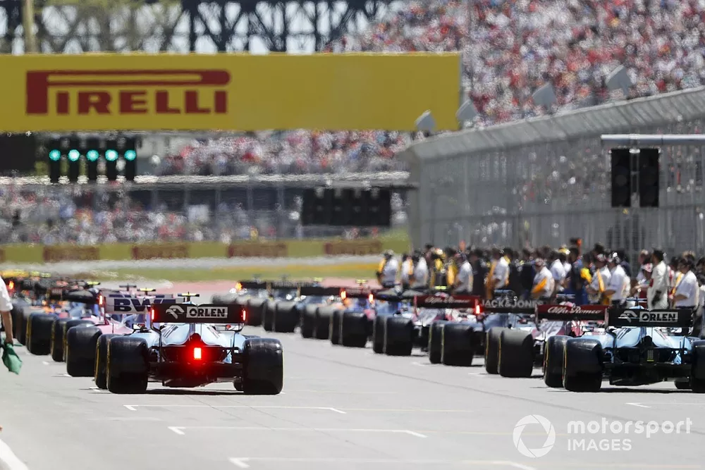 Mechanics clear the grid prior to the start of the formation lap