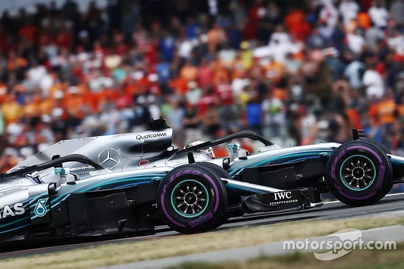 Lewis Hamilton, Mercedes AMG F1 W09, and Valtteri Bottas, Mercedes AMG F1 W09, wave in celebration of victory