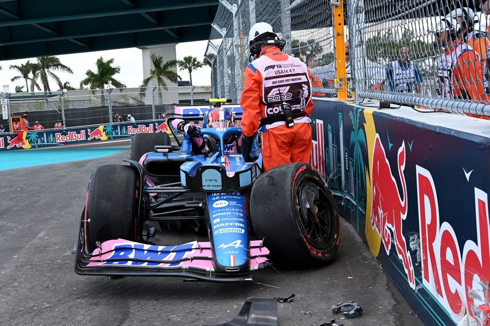 Marshals assist Esteban Ocon, Alpine A522, after a crash