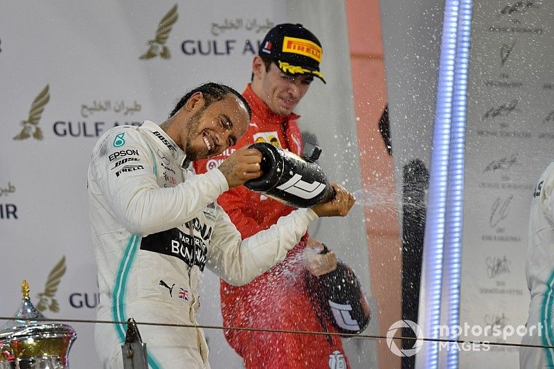 Lewis Hamilton, Mercedes AMG F1, 1st position, Charles Leclerc, Ferrari, 3rd position, and Valtteri Bottas, Mercedes AMG F1, 2nd position, spray Champagne on the podium