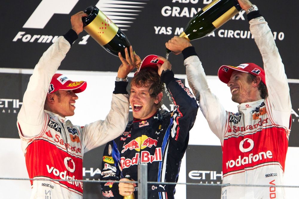 Lewis Hamilton, McLaren MP4-25 Mercedes, 2nd position, and Jenson Button, McLaren MP4-25 Mercedes, 3rd position, soak new world champion Sebastian Vettel, Red Bull Racing RB6 Renault, 1st position