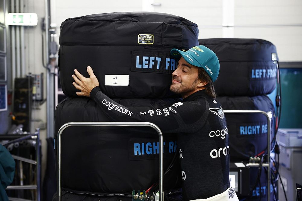 Fernando Alonso, Aston Martin F1 Team, hugs the tyre warmers