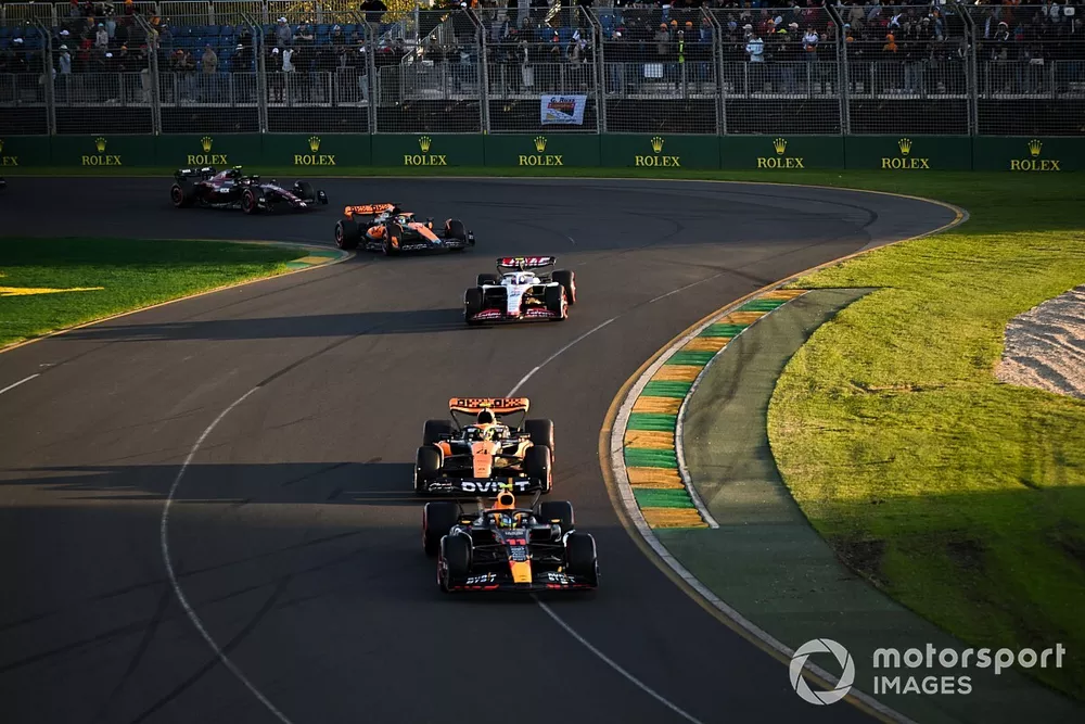 Sergio Perez, Red Bull Racing RB19, leads Lando Norris, McLaren MCL60, Nico Hulkenberg, Haas VF-23, and Oscar Piastri, McLaren MCL60