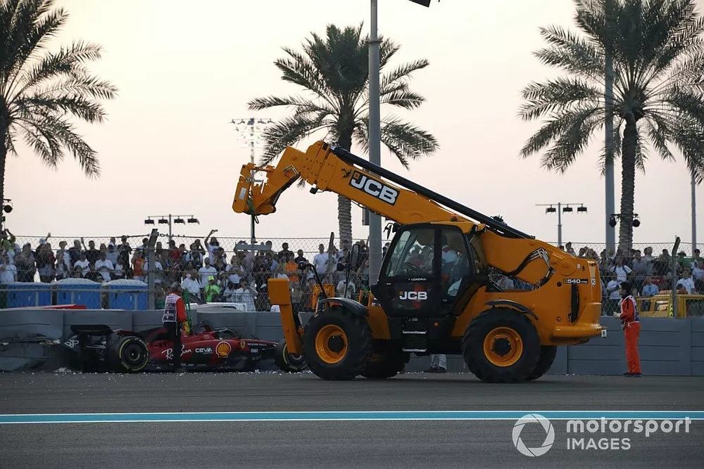 Marshals remove the damaged car of Carlos Sainz, Ferrari SF-23, from the circuit after a crash in FP2