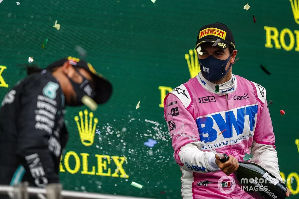 Sergio Perez, Racing Point, 2nd position, blasts Lewis Hamilton, Mercedes-AMG F1, 1st position, with Champagne on the podium