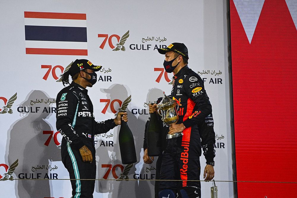 Lewis Hamilton, Mercedes-AMG F1, 1st position, and Alex Albon, Red Bull Racing, 3rd position, on the podium