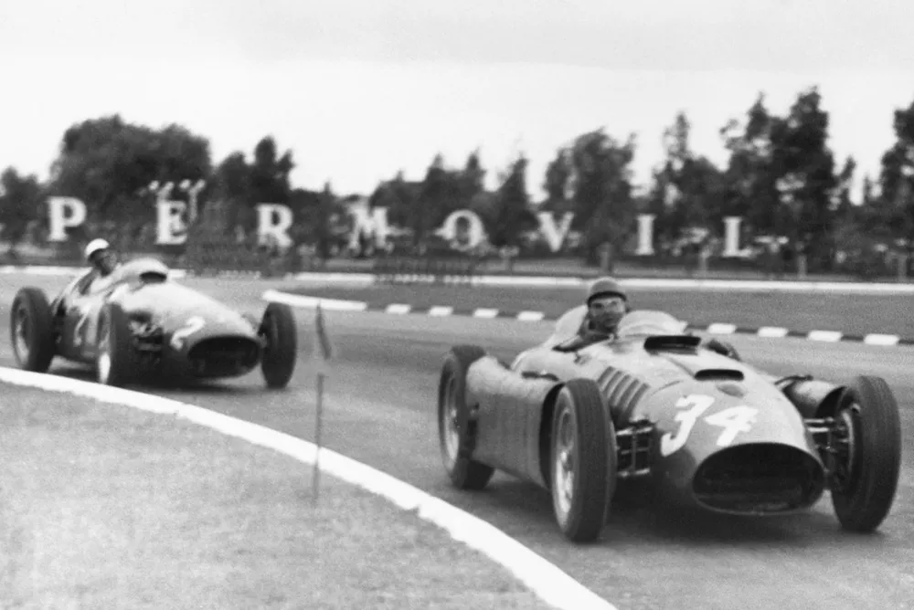 Luigi Musso/Juan Manuel Fangio (Lancia-Ferrari D50), 1st position, leads Stirling Moss (Maserati 250F)
