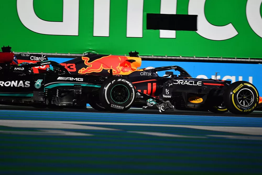 Max Verstappen, Red Bull Racing RB16B, and Lewis Hamilton, Mercedes W12, make contact as they battle for position