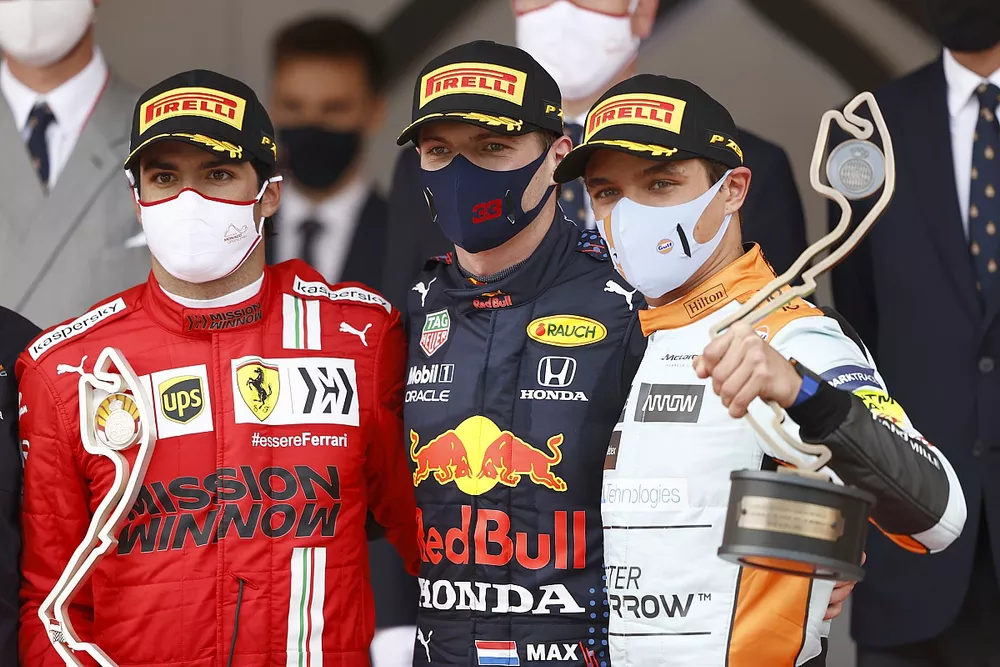Carlos Sainz Jr., Ferrari, 2nd position, Max Verstappen, Red Bull Racing, 1st position, and Lando Norris, McLaren, 3rd position, on the podium