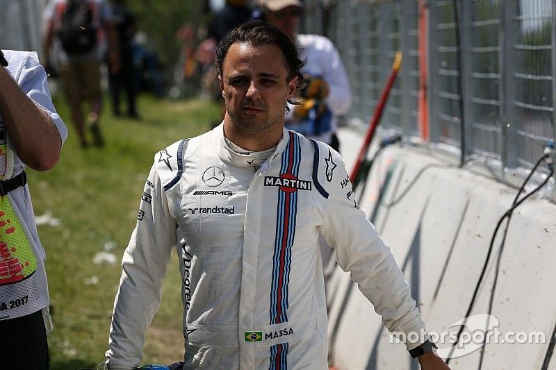 Race retiree Felipe Massa, Williams walks back after after crashing out of the race