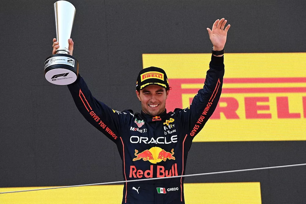 Sergio Perez, Red Bull Racing, 2nd position, on the podium with his trophy 