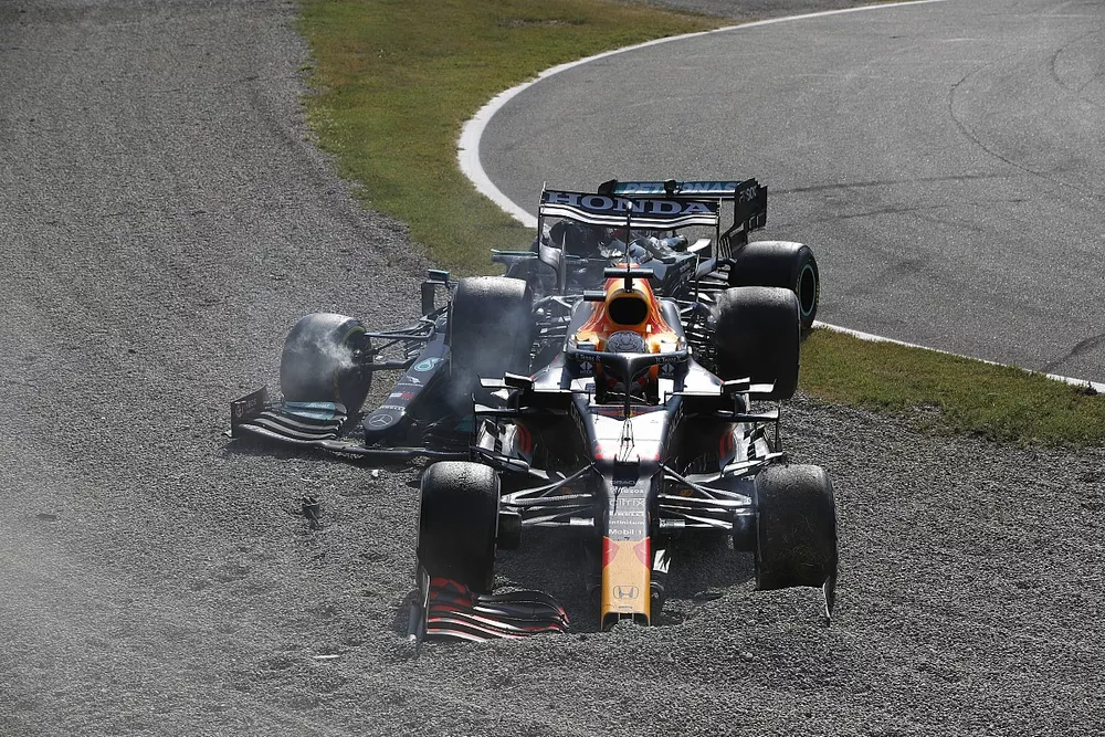 Max Verstappen, Red Bull Racing RB16B, and Lewis Hamilton, Mercedes W12, collide at the first chicane and retire from the race