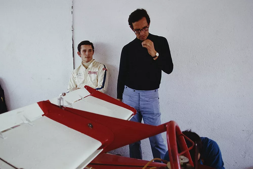 Jacky Ickx and Mauro Forghieri with Ickx's Ferrari 312B in the garage