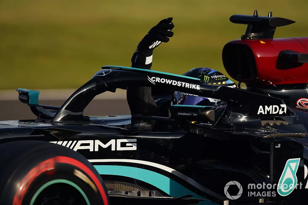Lewis Hamilton, Mercedes W12, waves from his cockpit after securing pole