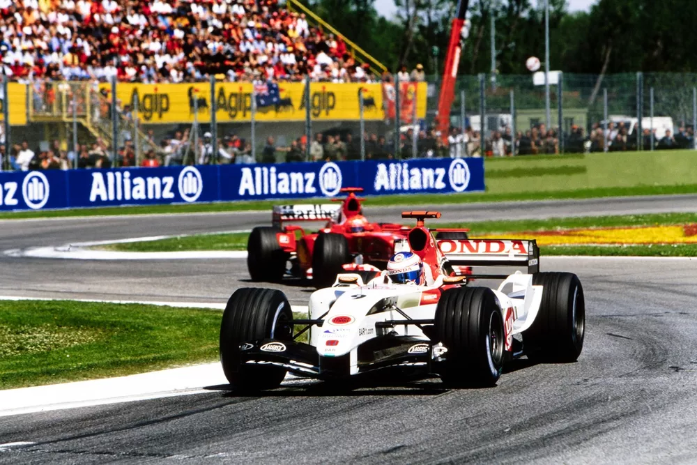 Jenson Button, BAR 006 Honda, leads Michael Schumacher, Ferrari F2004.