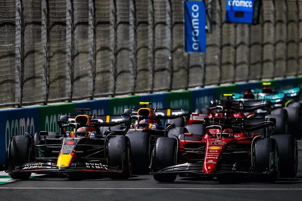 Charles Leclerc, Ferrari F1-75, battles with Max Verstappen, Red Bull Racing RB18, at the restart