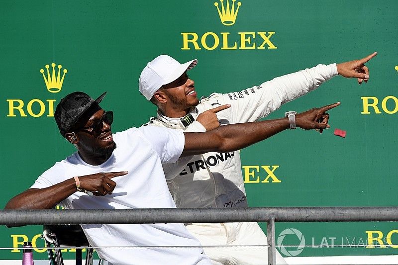 Race winner Lewis Hamilton, Mercedes AMG F1 celebrates on the podium with Usain Bolt