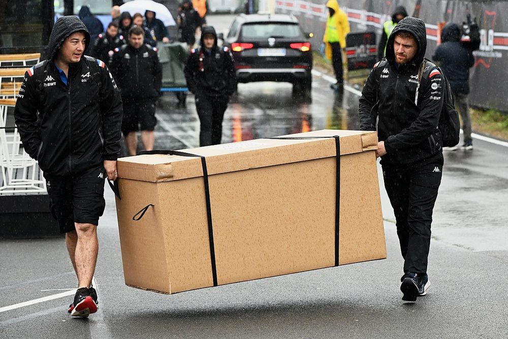 Alpine F1 Team carry equipment through the paddock