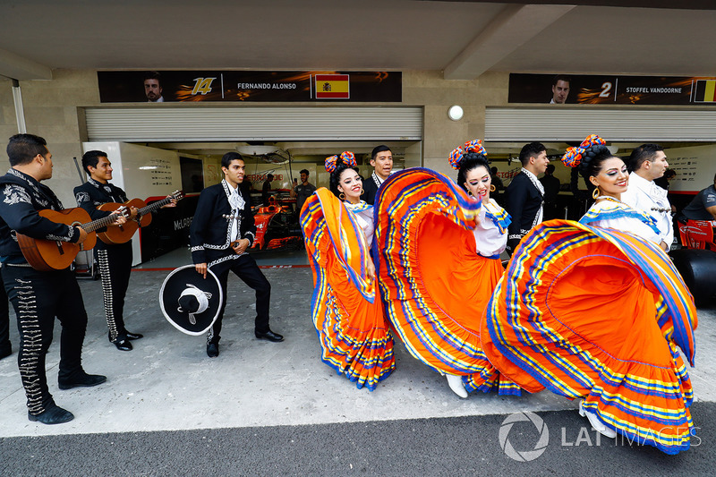 Dancers and a mariachi band outside the garages of Fernando Alonso and Stoffel Vandoorne, McLaren