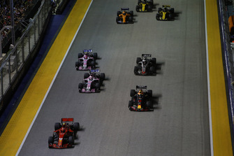 Kimi Raikkonen, Ferrari SF71H, leads Daniel Ricciardo, Red Bull Racing RB14, Sergio Perez, Racing Point Force India VJM11, Esteban Ocon, Racing Point Force India VJM11, Romain Grosjean, Haas F1 Team VF-18, Fernando Alonso, McLaren MCL33, Carlos Sainz Jr., Renault Sport F1 Team R.S. 18, and Nico Hulkenberg, Renault Sport F1 Team R.S. 18, at the start