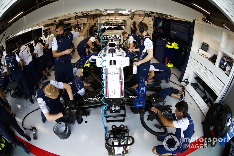 engineers work on the car of Lance Stroll, Williams FW41, in the garage