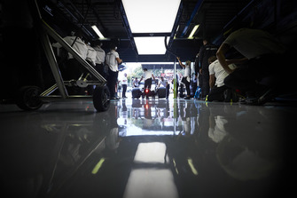 Mechanics wheel the Lewis Hamilton Mercedes AMG F1 W09 into the team's garage