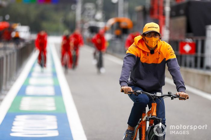 Carlos Sainz Jr., McLaren, cycles in the pit lane
