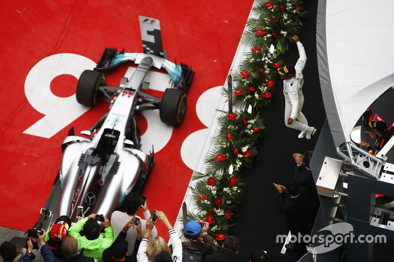 Lewis Hamilton, Mercedes AMG, celebrates victory on the podium with Max Verstappen, Red Bull Racing RB13 and Sebastian Vettel, Ferrari SF70H