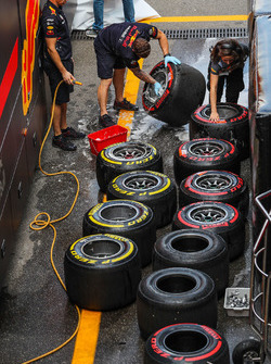 Red Bull Racing mechanics clean the Pirelli tyres