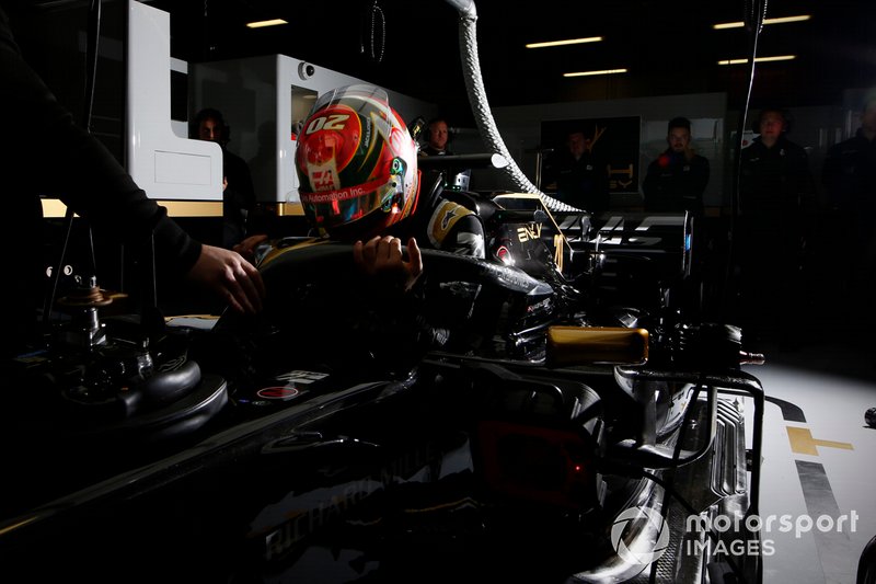 Kevin Magnussen, Haas F1 Team, enters his cockpit in the team's garage