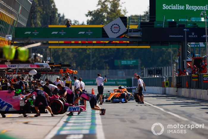 Lance Stroll, Racing Point RP20, es devuelto al garaje cuando Lando Norris, McLaren MCL35, llega a los pits