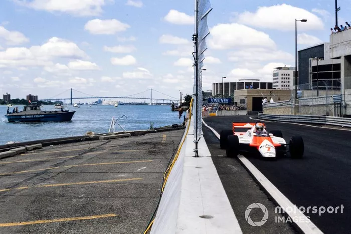John Watson, McLaren MP4-1B Ford, passes a Detroit police boat