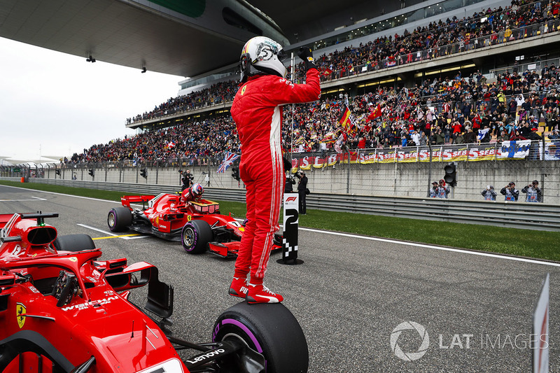 Sebastian Vettel, Ferrari, celebrates pole as team mate and front row starter Kimi Raikkonen, Ferrari, climbs out of his car