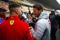 Romain Grosjean, Haas F1 Team, talks to Sebastian Vettel, Ferrari