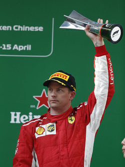 Kimi Raikkonen, Ferrari, 3rd position, on the podium with his trophy