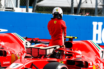 Pole man Kimi Raikkonen, Ferrari, climbs out of his car after team mate Sebastian Vettel, Ferrari