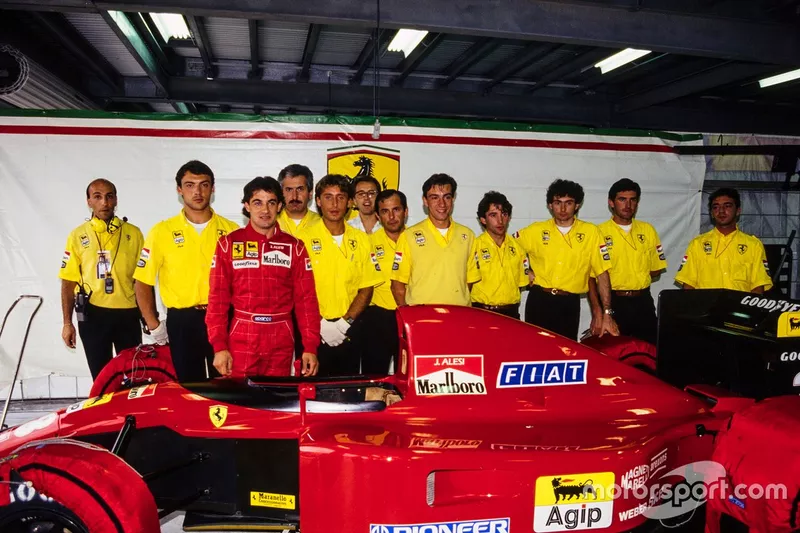 Jean Alesi with his Ferrari 643 and the team in the garage