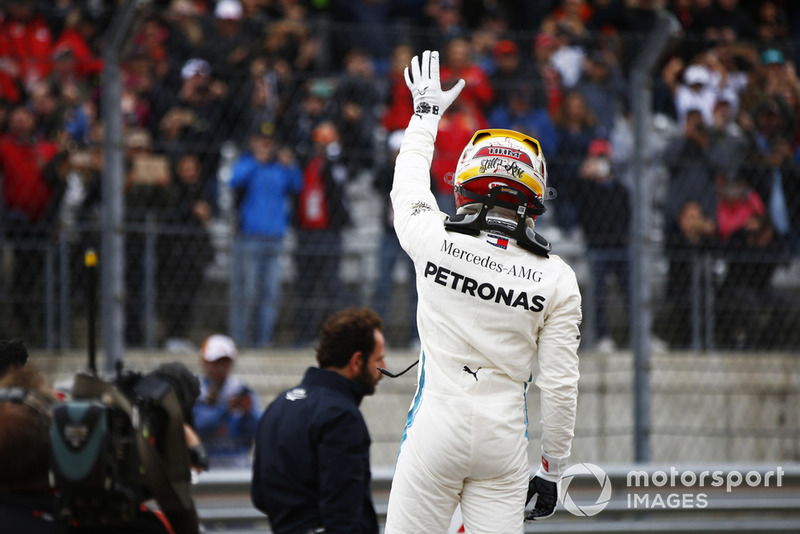 Lewis Hamilton, Mercedes AMG F1, waves to the fans after taking Pole Position