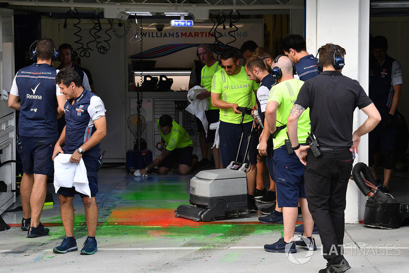 Williams mechanic clear aero paint from the garage floor