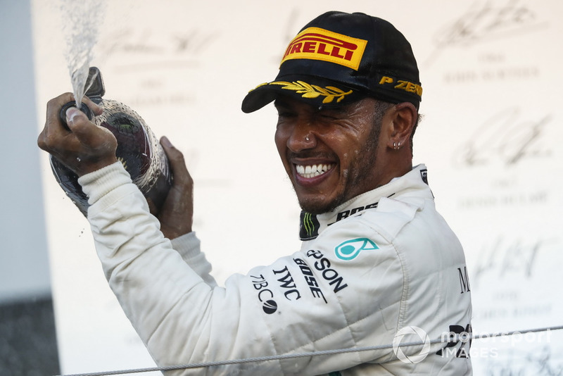 Il vincitore della gara Lewis Hamilton, Mercedes AMG F1, spruzza lo Champagne sul podio