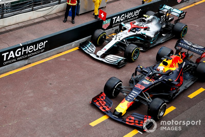 Max Verstappen, Red Bull Racing RB15, and Valtteri Bottas, Mercedes AMG W10, battle in the pit lane