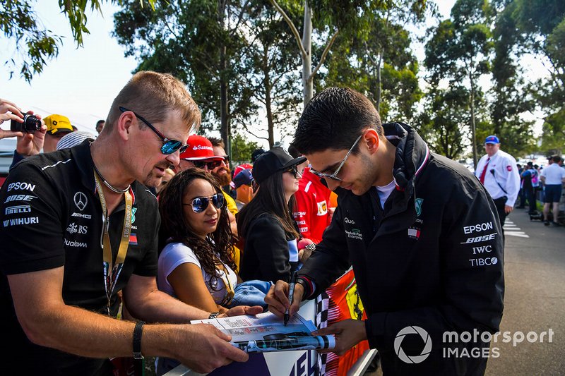 Esteban Ocon, Mercedes AMG F1 signs an autograph for a fan.